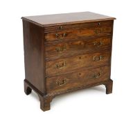 A George III mahogany chest, with brushing slide and four graduated long drawers on bracket feet,