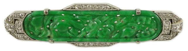An Art Deco white gold, jadeite and diamond set bar brooch, the jadeite with carved foliate