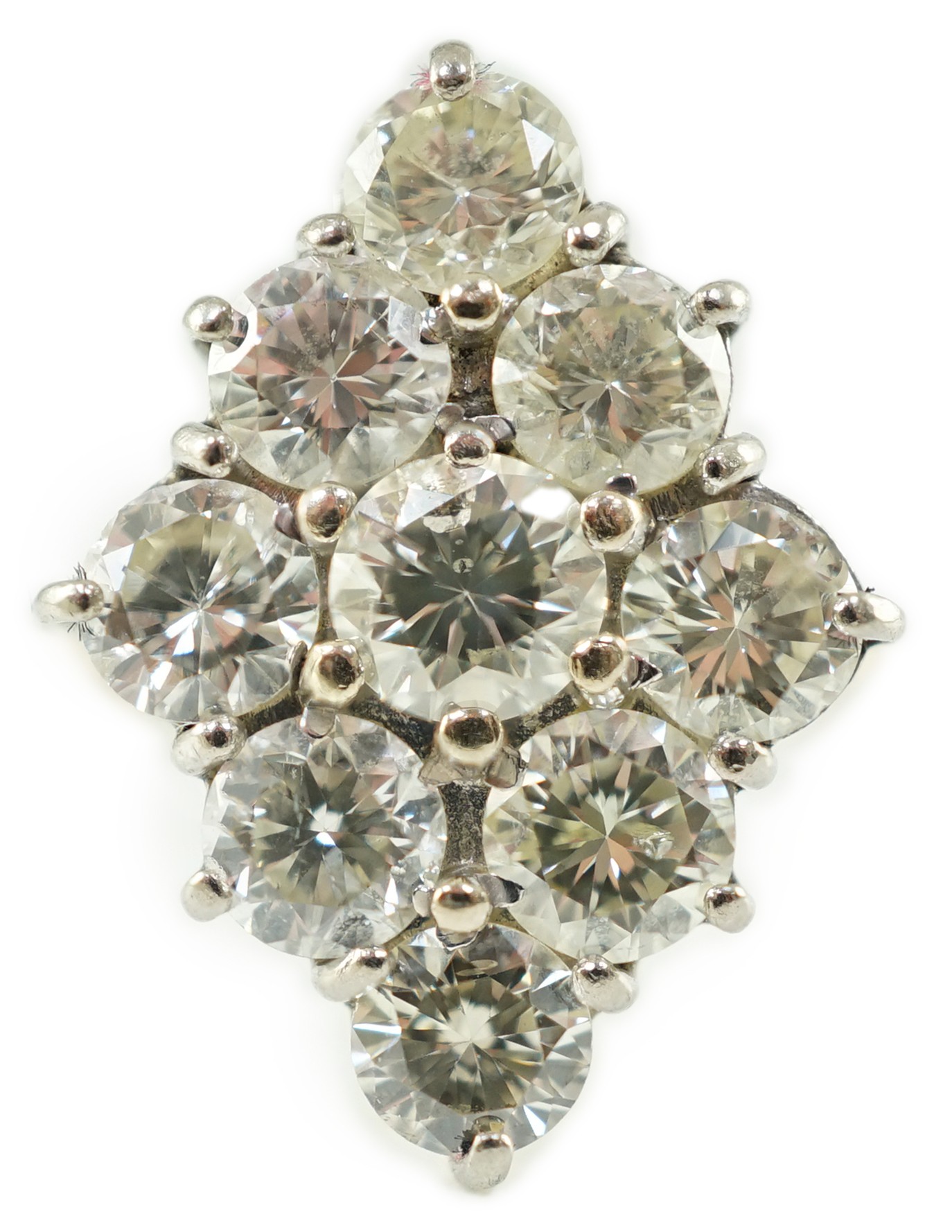 An 18ct white gold and nine stone diamond cluster set marquise shaped diamond ring, with a raised