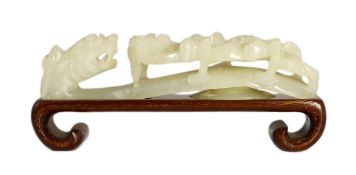 A Chinese white jade ‘dragon’ belt hook, 19th century, carved in high relief and openwork with a