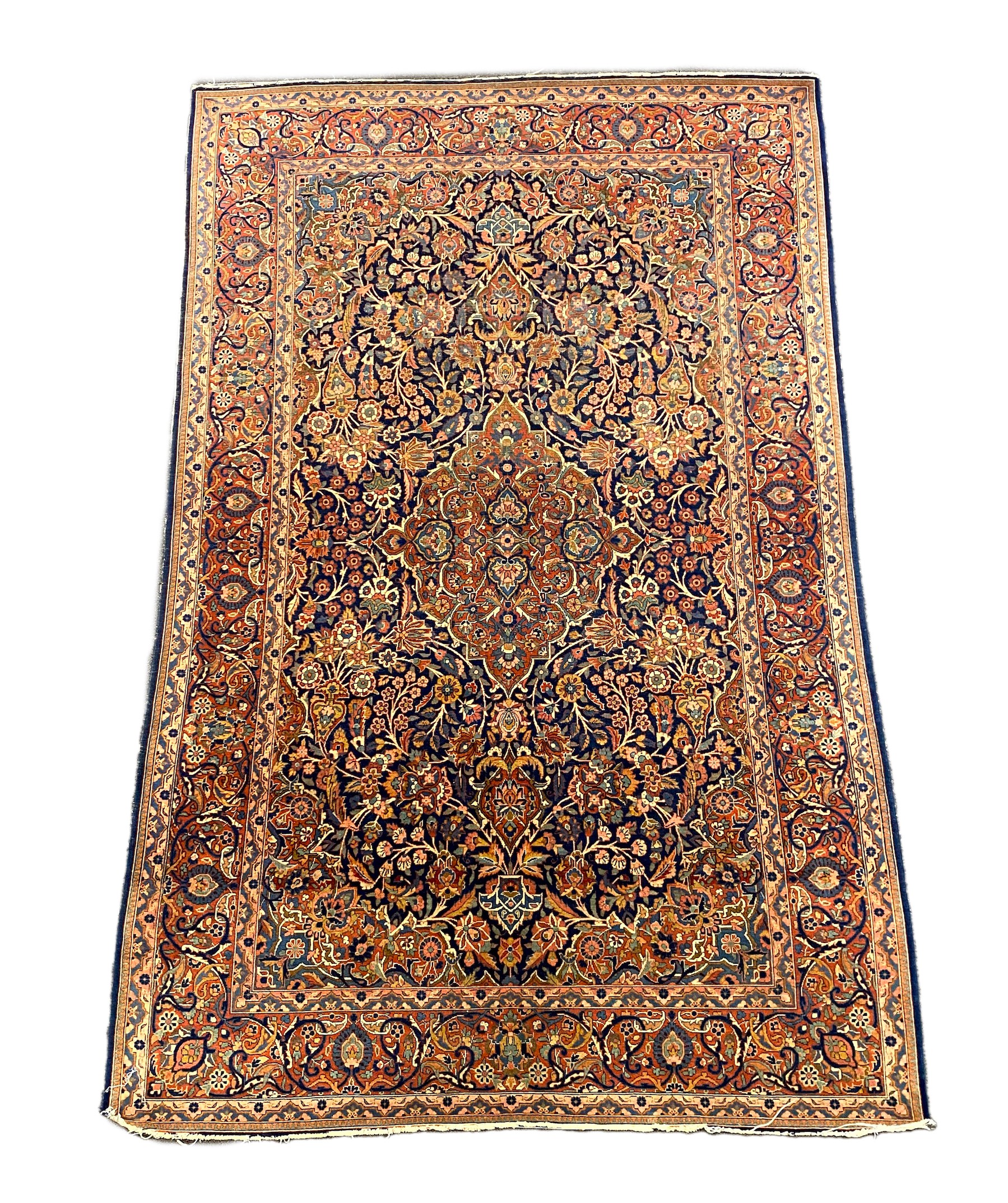 An early 20th century Kashan blue ground rug, with central lobed floral medallion within a triple