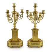 A pair of 19th century French ormolu five light candelabra, with foliate scroll branches and stepped