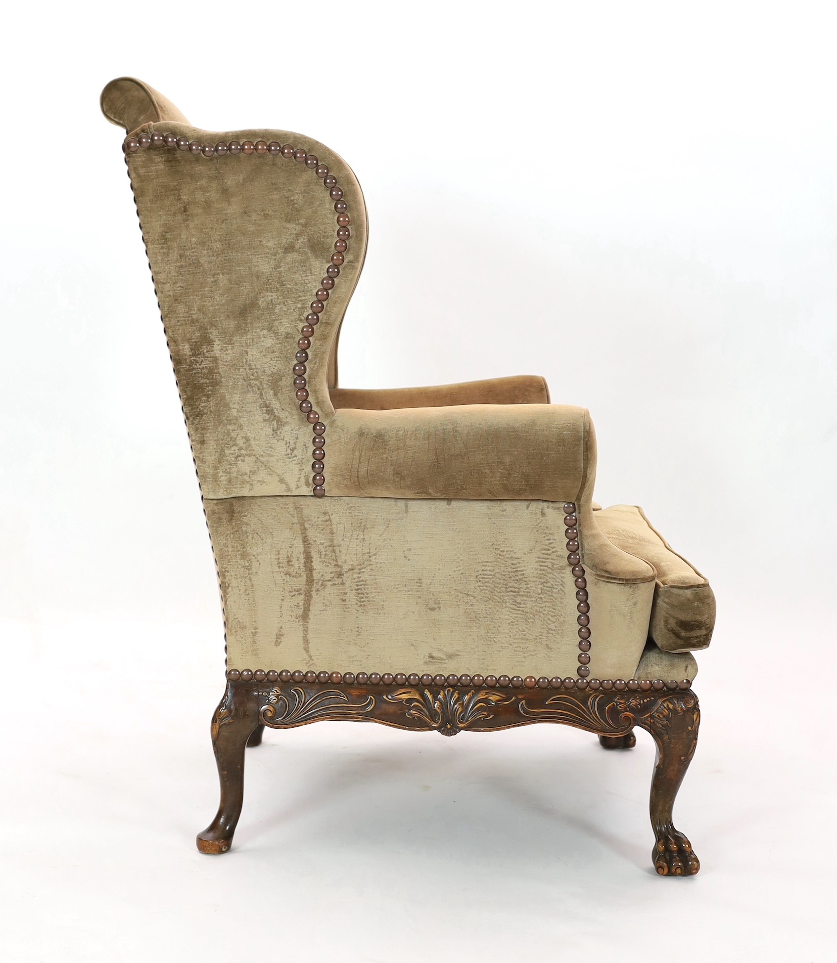 An Irish mahogany wing armchair, in George III style, with foliate scroll carved apron, on - Image 4 of 4