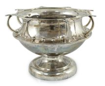 A George V Arts & Crafts planished silver octuple handled pedestal punch bowl, by Albert Edward