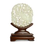 A Chinese white jade ‘phoenix and peony’ reticulated plaque, early 19th century, the phoenix with