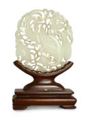 A Chinese white jade ‘phoenix and peony’ reticulated plaque, early 19th century, the phoenix with