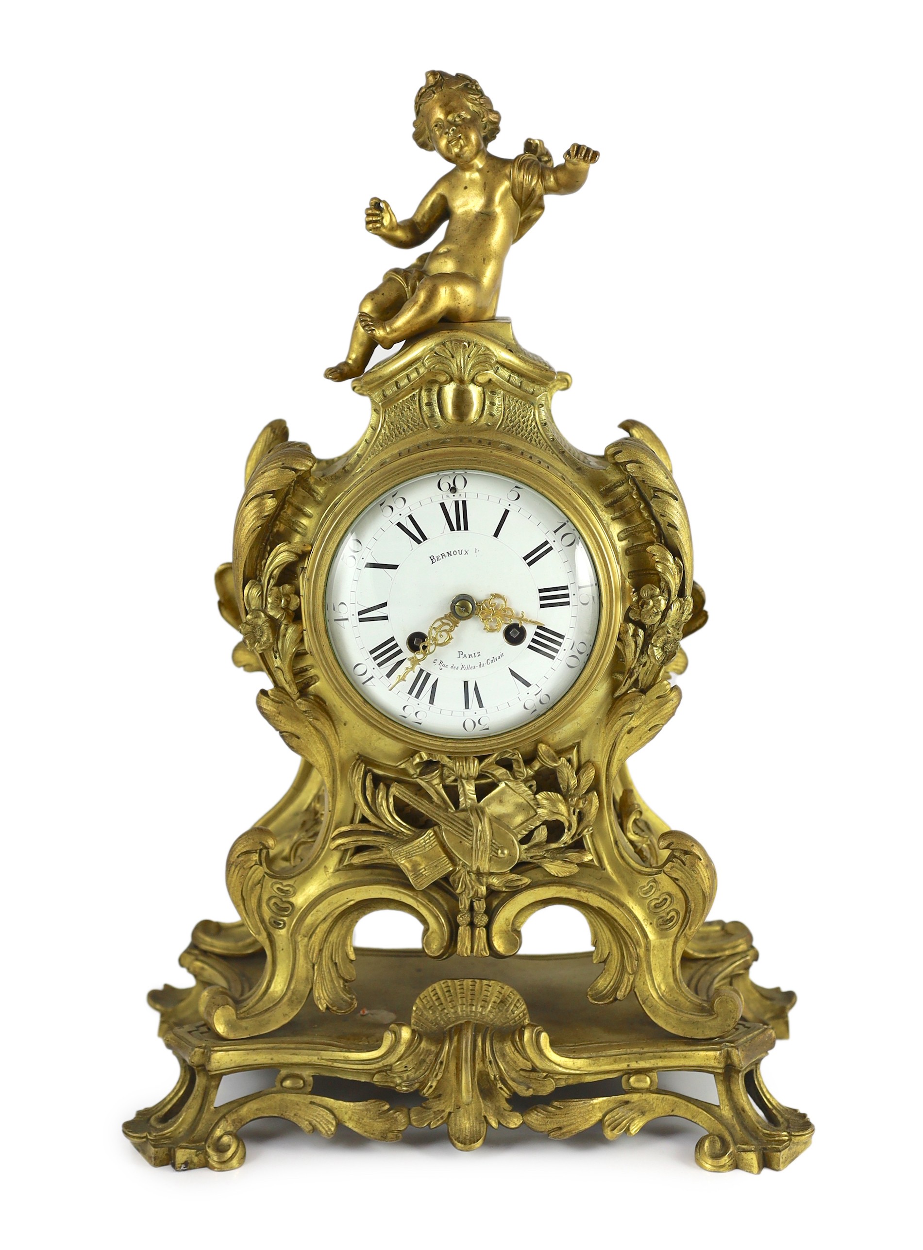 Bernoux of Paris. A 19th century Louis XV style ormolu mantel clock, with putto finial, enamelled