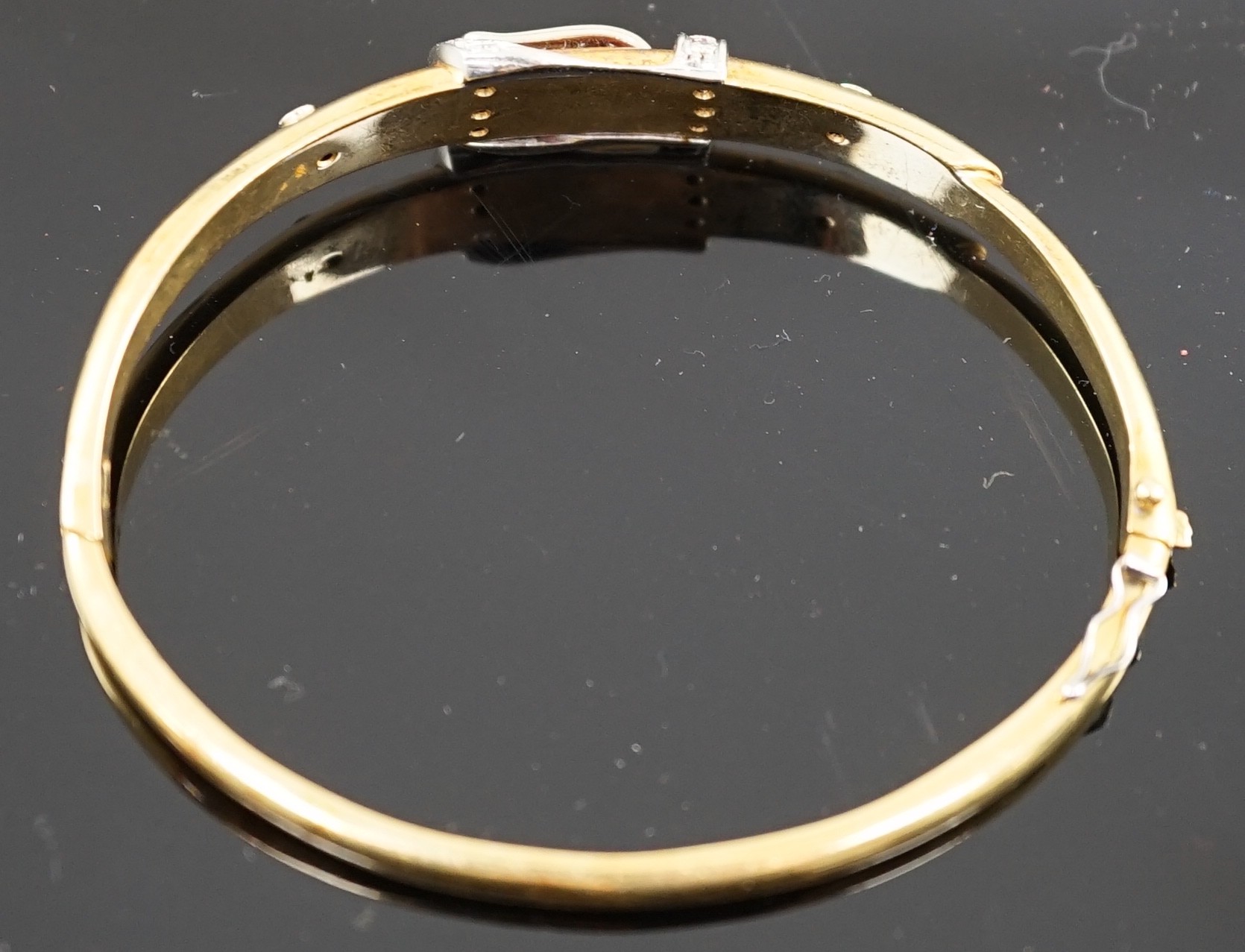 A gold and diamond set hinged bangle with central buckle motif, interior diameter 58mm, gross weight - Image 2 of 3