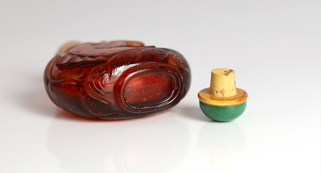 A Chinese ruby red glass ‘leaping carp’ snuff bottle, 1750-1850, each side carved in high relief - Image 6 of 6