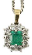 An 18ct white and yellow gold, emerald and diamond set shaped rectangular cluster pendant, on a