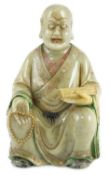 A Chinese soapstone seated figure of a luohan, 18th century, the figure holding a rosary bead