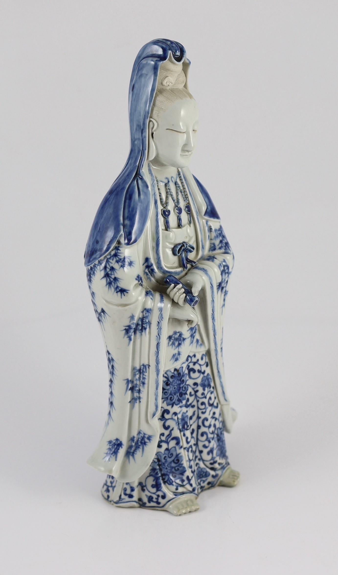 A Chinese blue and white standing figure of Guanyin, late 19th century, holding a scroll in her left - Image 2 of 5