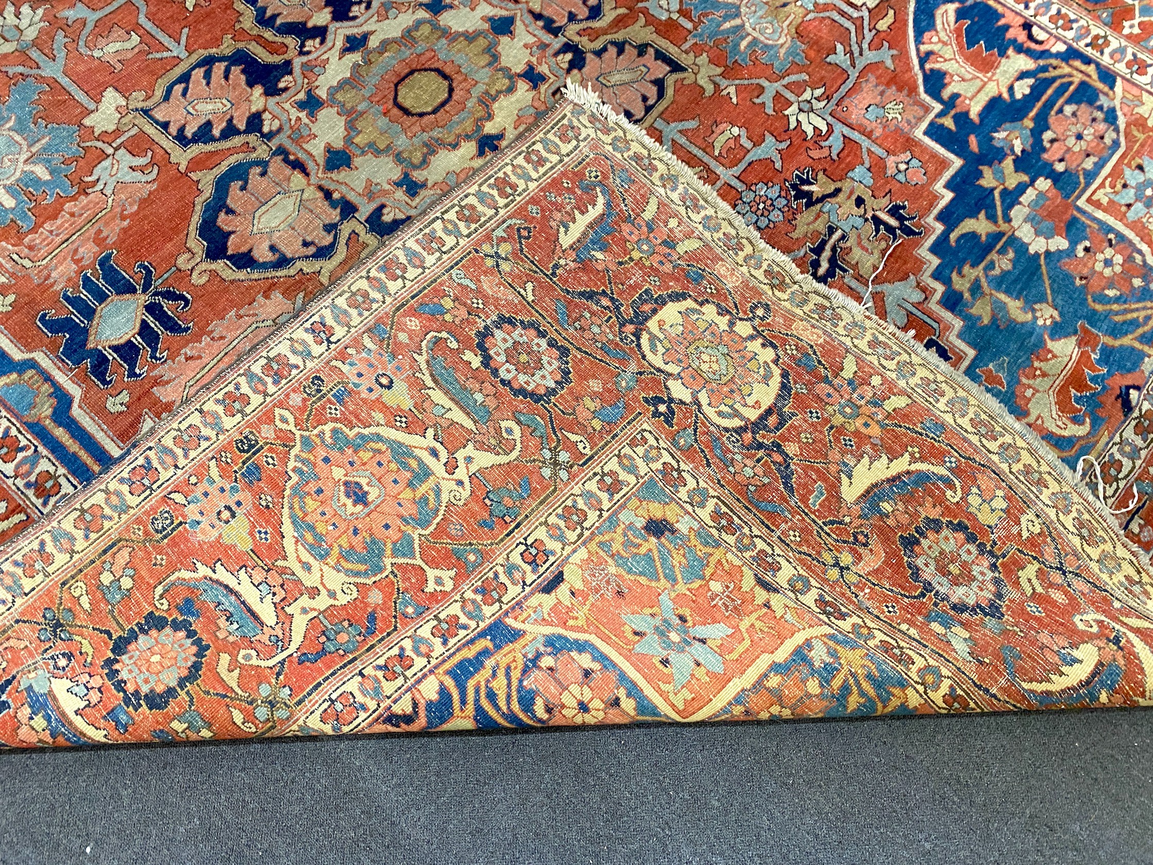 An antique Heriz brick red ground carpet, with large central floral medallion within a wide - Image 7 of 7