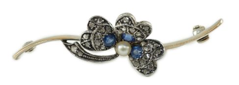 A 1920’s white gold, sapphire, cultured pearl and rose cut diamond set shamrock bar brooch, numbered