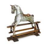 A Victorian carved and painted wood rocking horse, with remnants of original dapple grey finish,