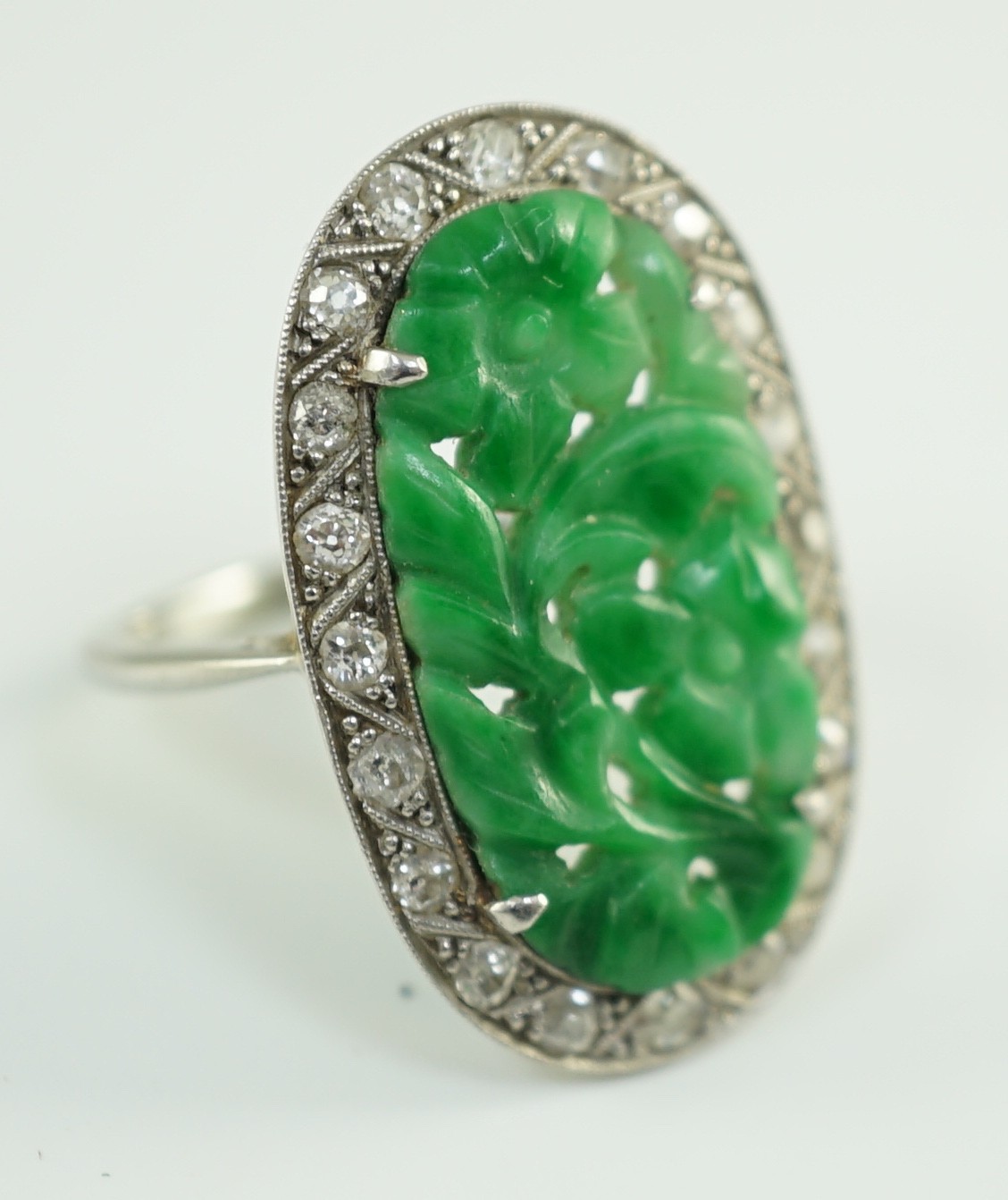 A 1920's/1930's white gold, jadeite and diamond set oval dress ring, the foliate carved jadeite, - Image 3 of 4