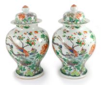 A pair of large Chinese famille verte jars and covers, late 19th century, each painted with
