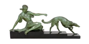 Armand Godard. A French Art Deco patinated bronze and black marble group of a classical woman and