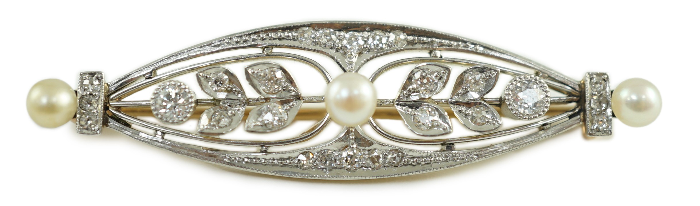 An early to mid 20th century gold and platinum, pearl and round cut millegrain set diamond cluster