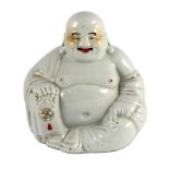 A Chinese porcelain figure of Budai, Republic period, holding a rosary in his right hand, his robe