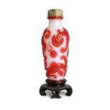 A Chinese red overlay on white glass ‘chilong’ snuff bottle, 1780-1850, carved in relief with two