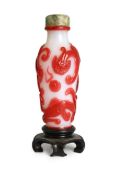 A Chinese red overlay on white glass ‘chilong’ snuff bottle, 1780-1850, carved in relief with two