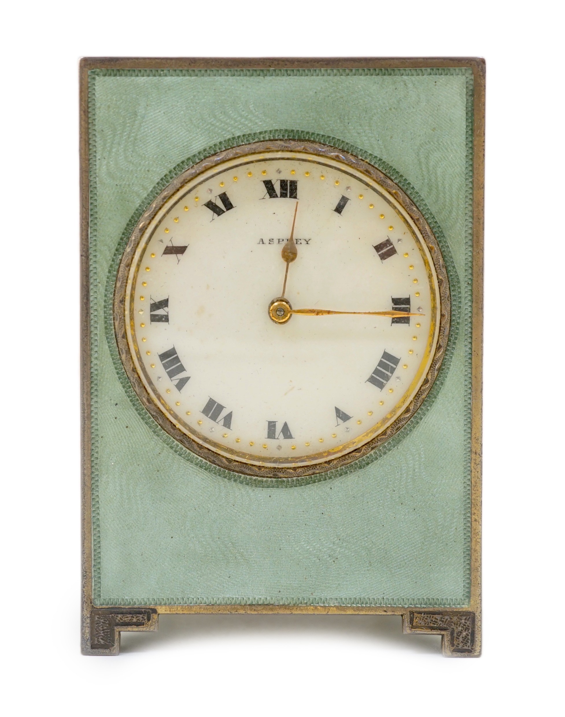A George V silver and green guilloche enamelled travelling timepiece, retailed by Asprey, in