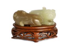 A Chinese pale celadon and brown jade group of two cats, 19th century, 5.1cm, wood stand, tiny