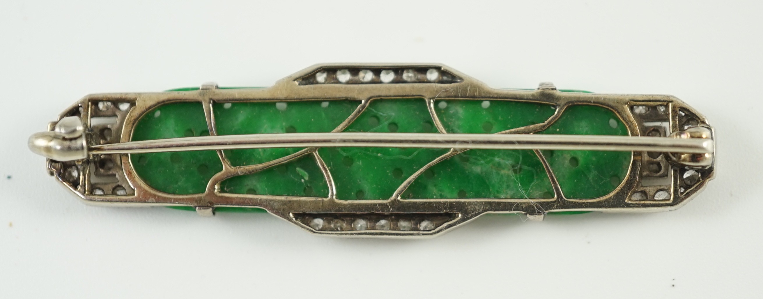 An Art Deco white gold, jadeite and diamond set bar brooch, the jadeite with carved foliate - Image 2 of 3