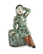 A Chinese enamelled porcelain figure of a Han Chinese woman, late 19th century, seated on a tree