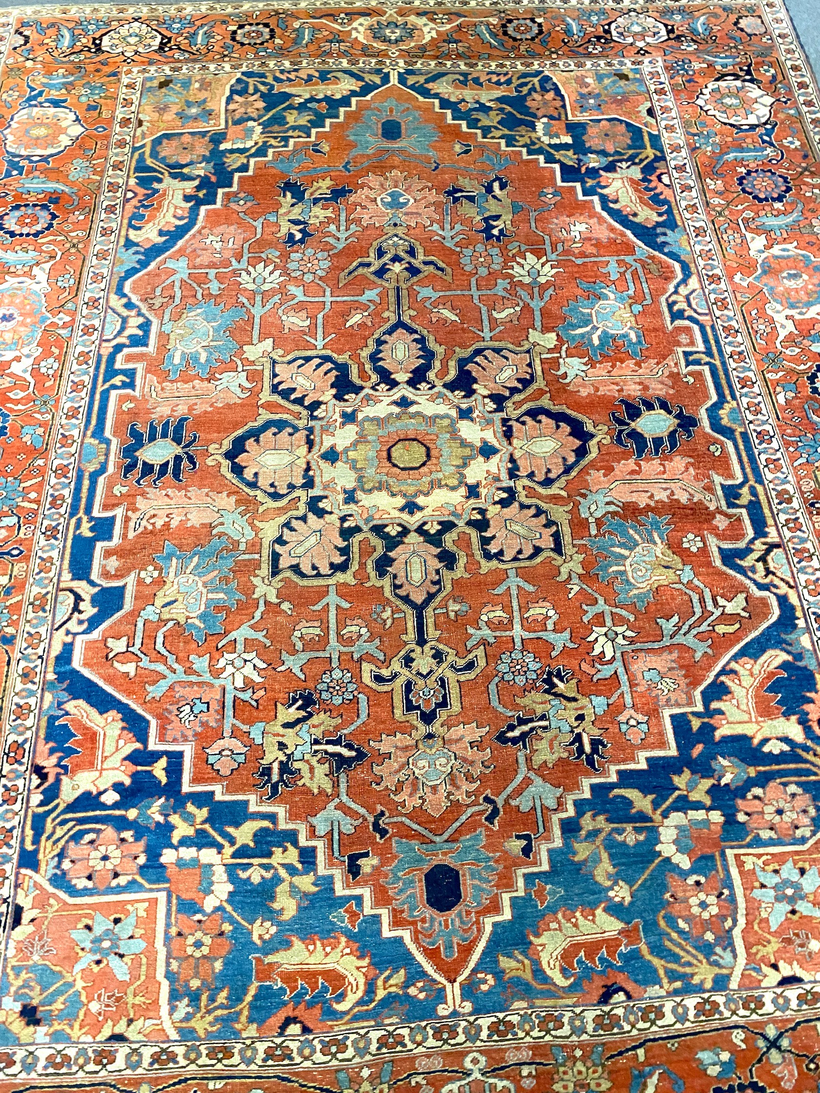 An antique Heriz brick red ground carpet, with large central floral medallion within a wide - Image 4 of 7