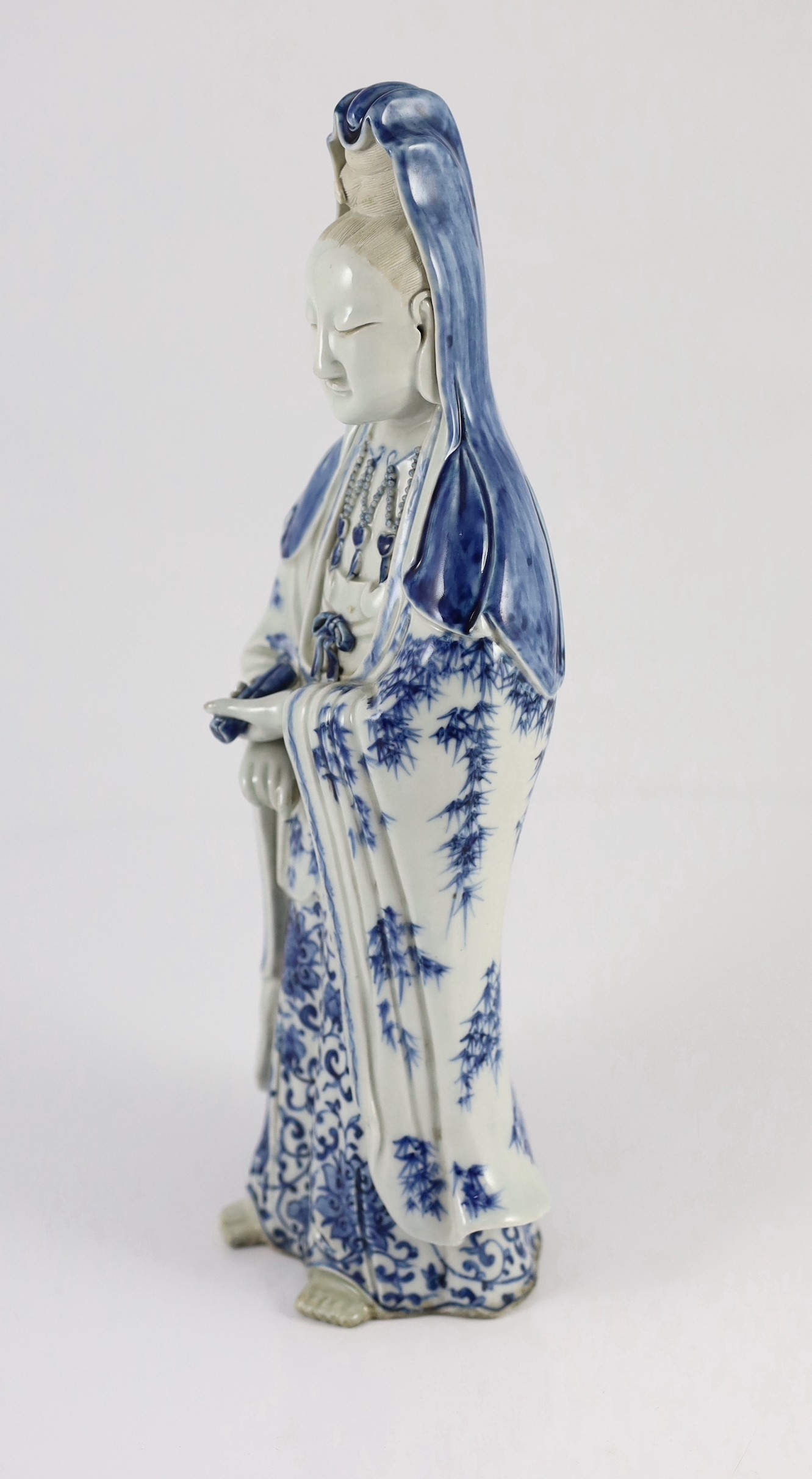 A Chinese blue and white standing figure of Guanyin, late 19th century, holding a scroll in her left - Image 3 of 5