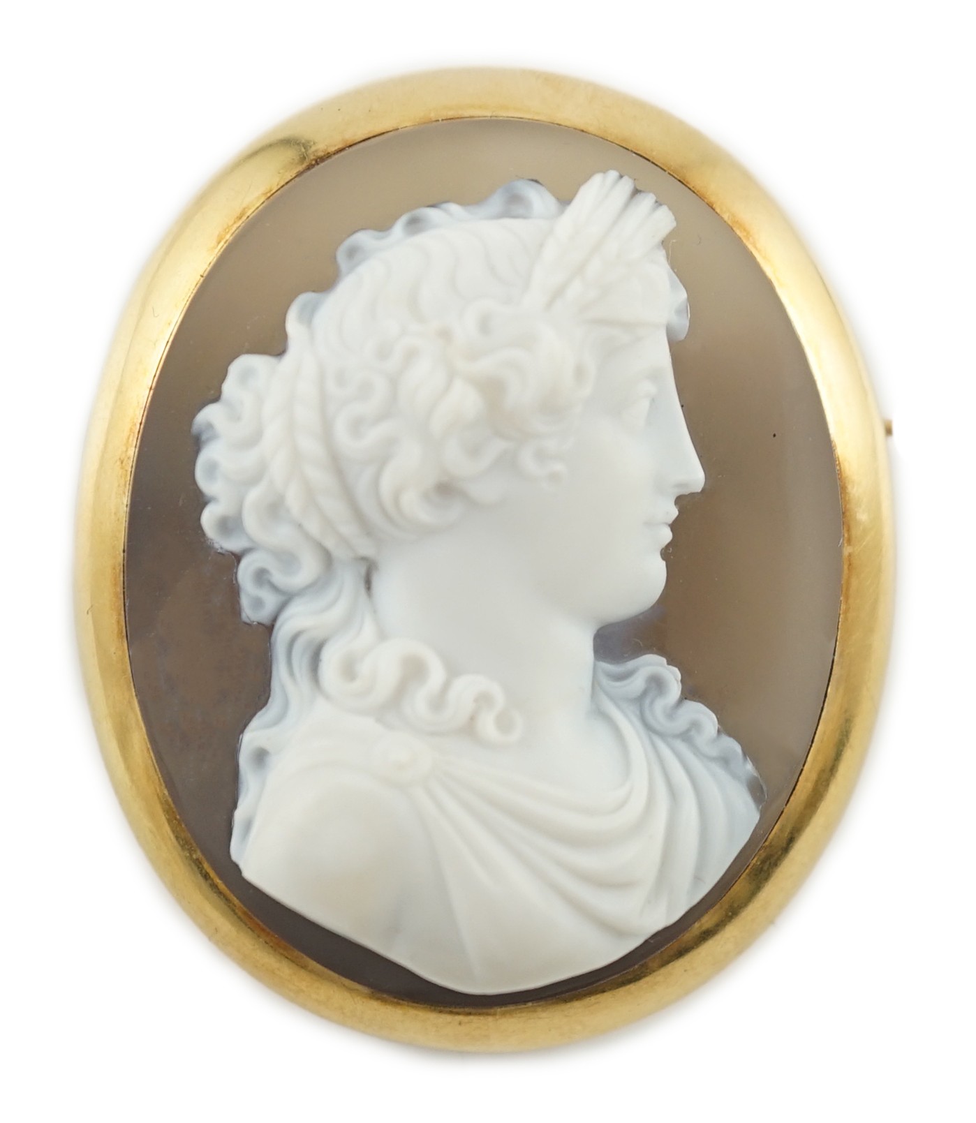 A late 19th/early 20th century gold mounted chalcedony cameo set oval brooch, carved with the bust