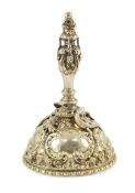 An Elizabeth II cast silver hand bell, by Garrard & Co. with figural finial and domed base decorated