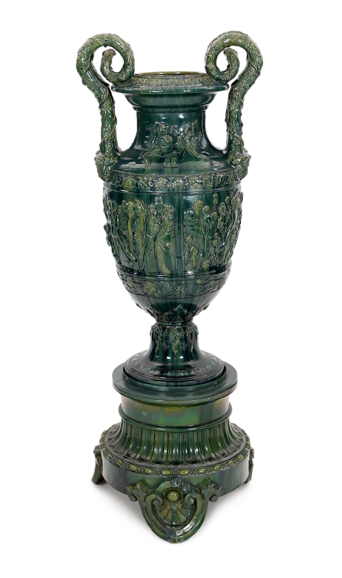 A massive Continental majolica green glazed campana vase and associated stand, late 19th century,