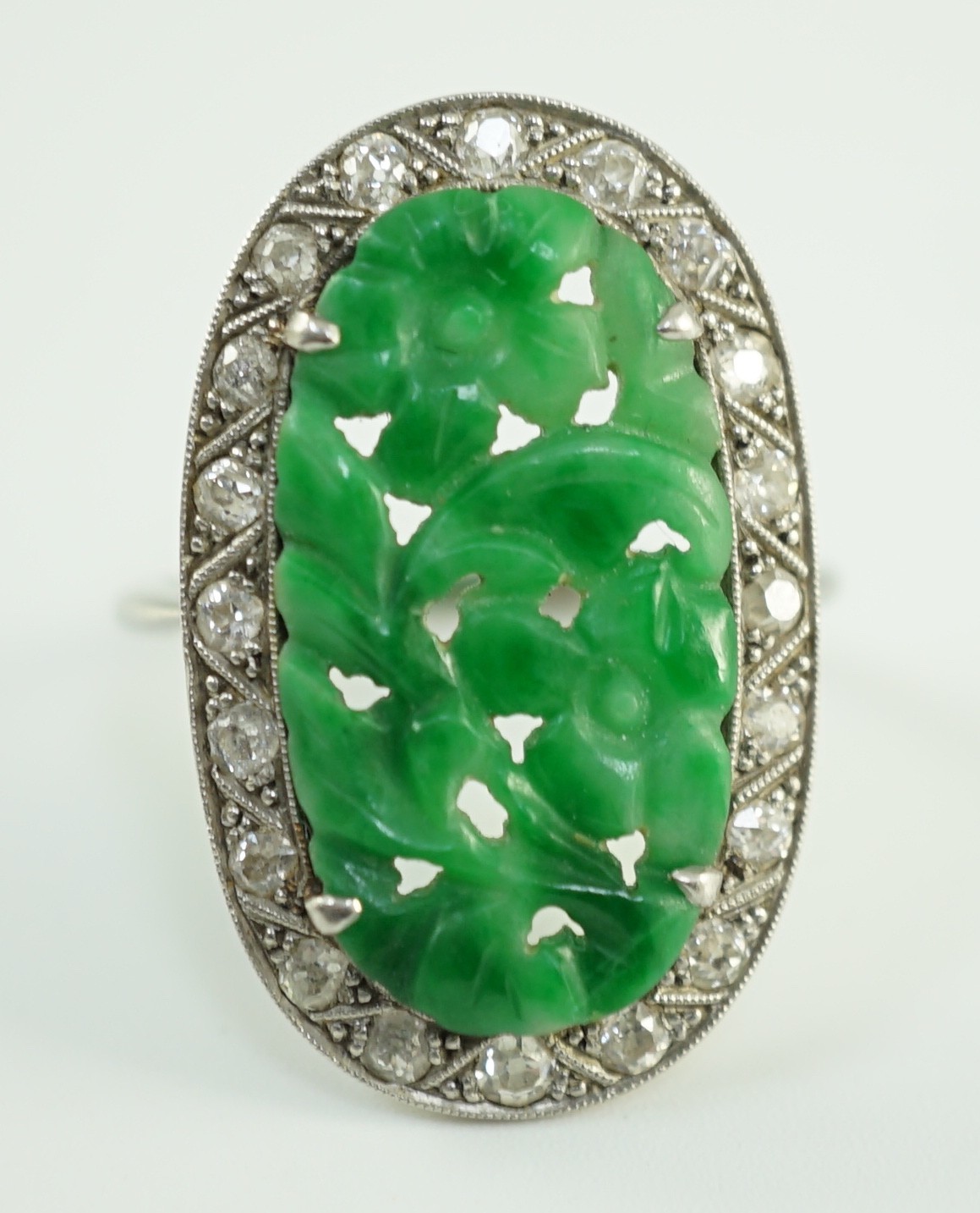 A 1920's/1930's white gold, jadeite and diamond set oval dress ring, the foliate carved jadeite, - Image 4 of 4