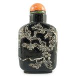 A Chinese smoky quartz snuff bottle, 1780-1820, of flattened shield shape, the carver skilfully