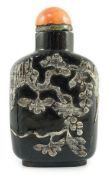 A Chinese smoky quartz snuff bottle, 1780-1820, of flattened shield shape, the carver skilfully