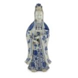 A Chinese blue and white standing figure of Guanyin, late 19th century, holding a scroll in her left