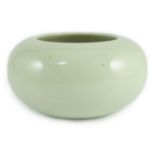 A Chinese celadon glazed water pot or alms bowl, late 19th century, with concave and unglazed