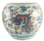 A large Chinese underglaze blue and copper red 'dragon' scroll vessel, of globular form, painted
