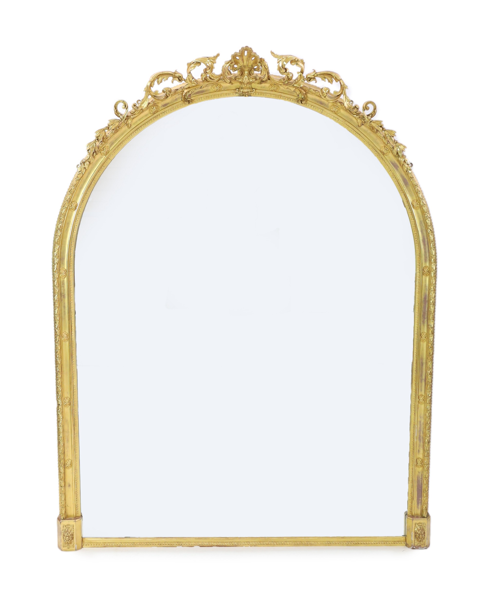 A Victorian giltwood and gesso overmantel mirror, of ornate arched form with foliate scroll and