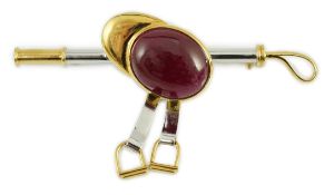 A late 20th century 18ct yellow and white gold, cabochon ruby set ‘jockey cap, riding crop and