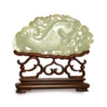 A Chinese pale celadon jade 'fish' plaque, 18th/19th century, carved and pierced with a leaping fish