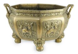 A large Chinese polished bronze octagonal jardiniere, 19th century, each side cast in relief with