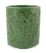 A large Chinese spinach green jade brushpot, bitong, carved in relief with scholars amid