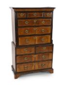 A George II featherbanded walnut chest on chest, with moulded cornice, three short and three