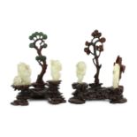 An assembled group of four Chinese pale celadon jade figures, 18th/19th century, the first a group