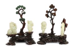 An assembled group of four Chinese pale celadon jade figures, 18th/19th century, the first a group
