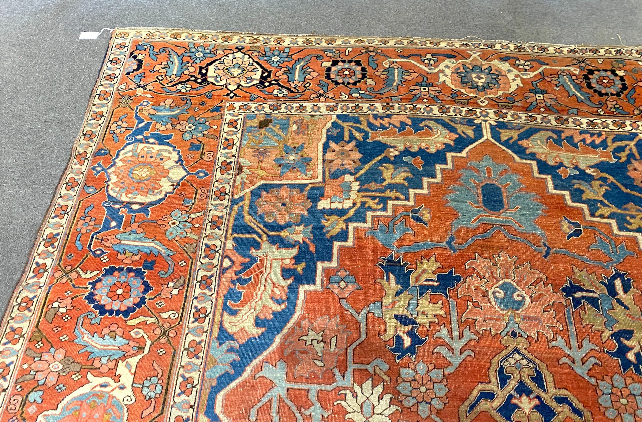 An antique Heriz brick red ground carpet, with large central floral medallion within a wide - Image 6 of 7